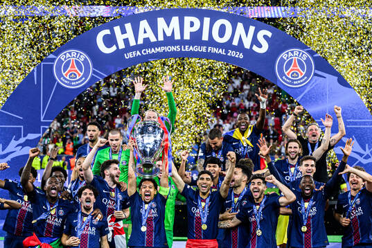 Players of Paris Saint-Germain celebrate with the trophy