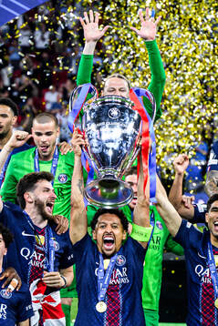 Players of Paris Saint-Germain celebrate with the trophy