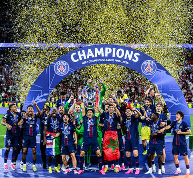 Players of Paris Saint-Germain celebrate with the trophy