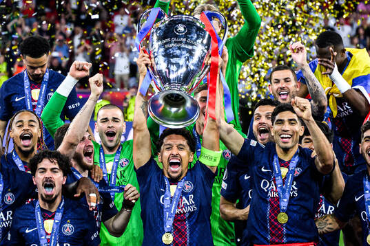 Players of Paris Saint-Germain celebrate with the trophy