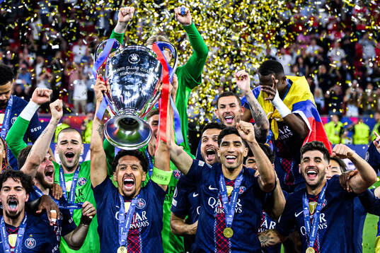 Players of Paris Saint-Germain celebrate with the trophy