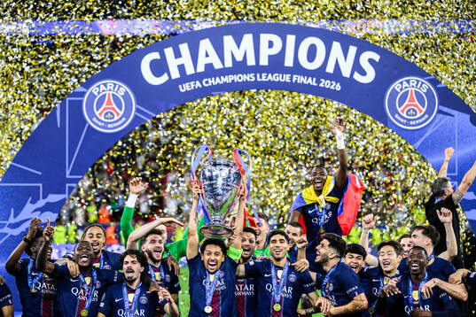 Players of Paris Saint-Germain celebrate with the trophy