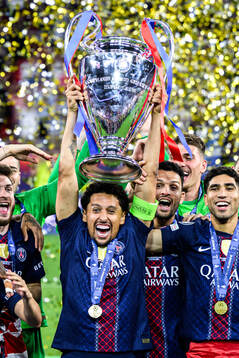 Players of Paris Saint-Germain celebrate with the trophy