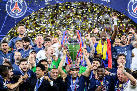 Players of Paris Saint-Germain celebrate with the trophy