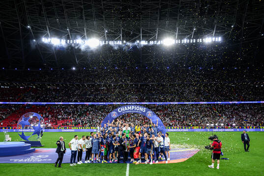 Players of Paris Saint-Germain celebrate with the trophy