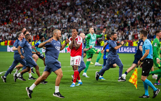 Players of Paris Saint-Germain celebrate and Gabriel of