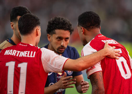 Gabriel of Arsenal is greeted by Marquinhos of Paris