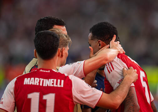 Gabriel of Arsenal is embraced by Martin Ødegaard and