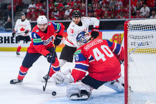 Johannes Johannesen and goaltender Henrik Haukeland of