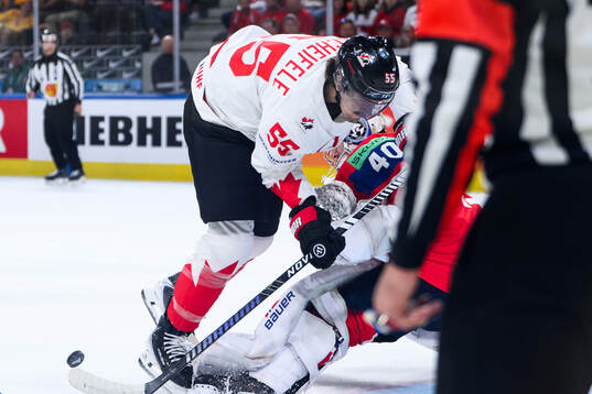 Mark Scheifele of Canada and goaltender Henrik Haukeland of