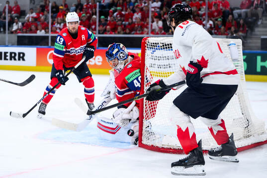 goaltender Henrik Haukeland of Norway and Robert Thomas of