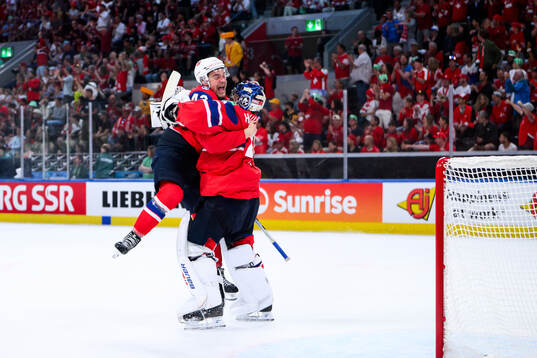 Max Krogdahl and goaltender Henrik Haukeland of Norway