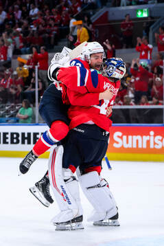 Max Krogdahl and goaltender Henrik Haukeland of Norway
