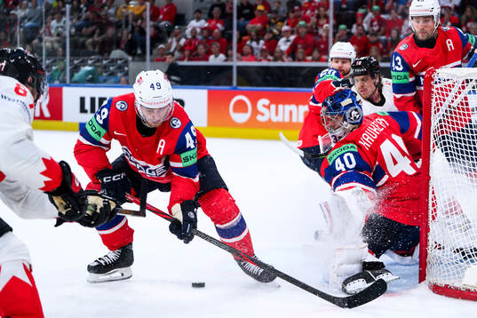 Christian Kåsastul and goaltender Henrik Haukeland of