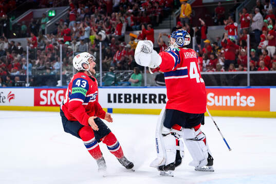 Max Krogdahl and goaltender Henrik Haukeland celebrate