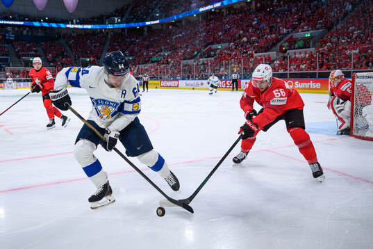 Mikael Granlund of Finland and Tim Berni of Switzerland
