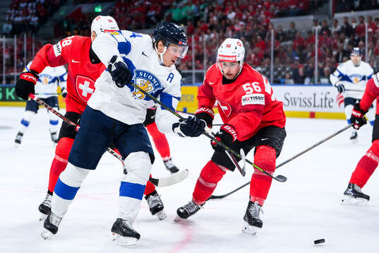 Mikael Granlund of Finland and Tim Berni of Switzerland