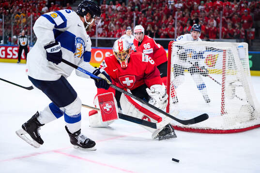 Alexander Barkov of Finland and Leonardo Genoni of