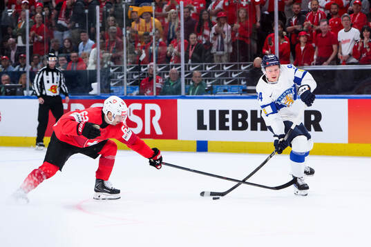 Denis Malgin of Switzerland  and Aatu Räty of Finland
