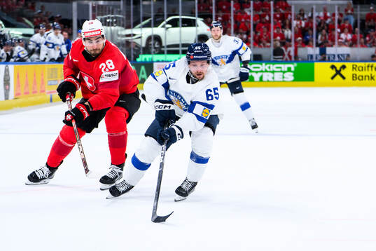 Timo Meier of Switzerland and Sakari Manninen of Finland