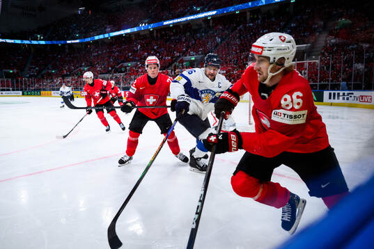 Alexander Barkov of Finland and Janis Moser of Switzerland