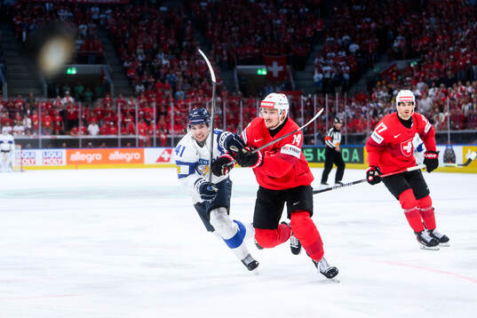 Ville Heinola of Finland and Dean Kukan of Switzerland