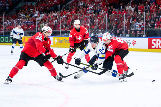 Nico Hischier and Janis Moser of Switzerland and Mikael