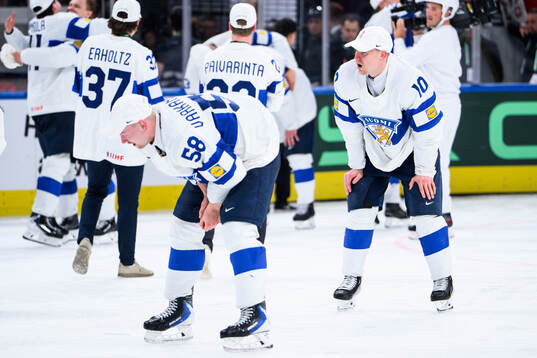 Urho Vaakanainen and Henri Jokiharju of Finland celebrate