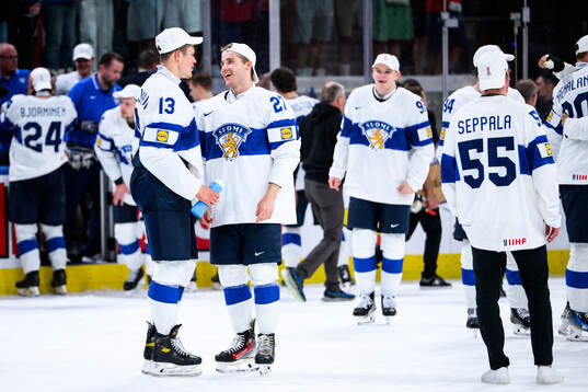 Jesse Puljujärvi and Janne Kuokkanen of Finland celebrate