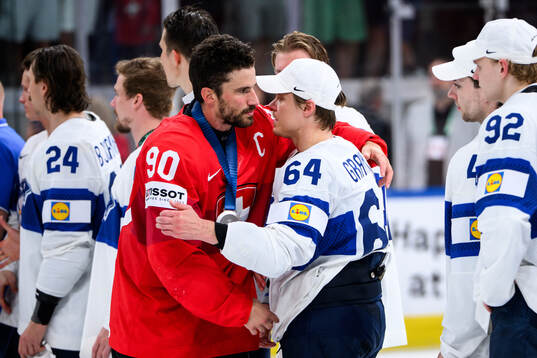 Roman Josi of Switzerland and Mikael Granlund of Finland