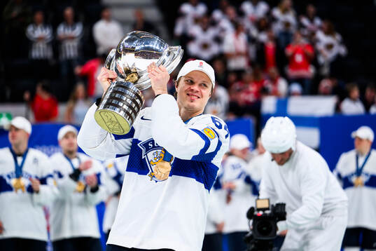 Mikael Granlund of Finland celebrates with the trophy