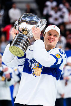 Mikael Granlund of Finland celebrates with the trophy