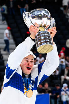 Jesse Puljujärvi of Finland celebrates with the trophy