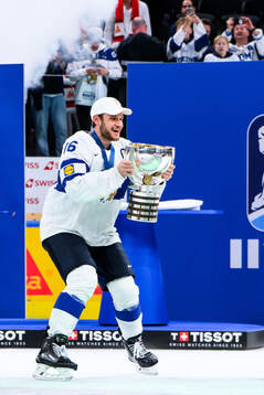 Alexander Barkov of Finland celebrates with the trophy