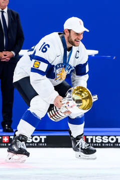 Alexander Barkov of Finland celebrates with the trophy