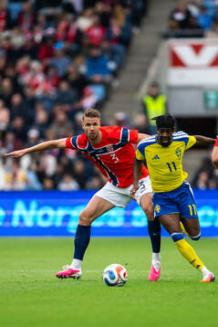 Kristoffer Ajer of Norway and Anthony Elanga of Sweden