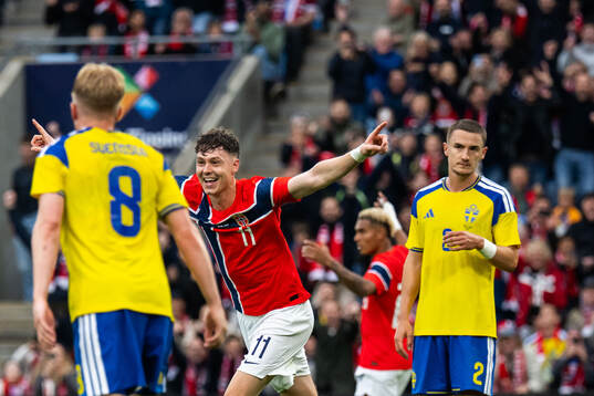 Jørgen Strand Larsen of Norway celebrates while Daniel