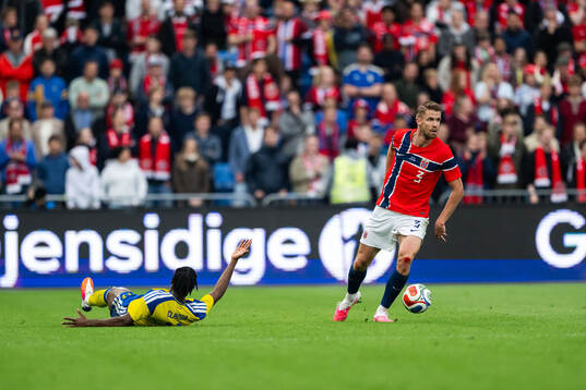 Anthony Elanga of Sweden and Kristoffer Ajer of Norway