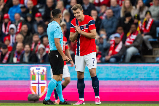 Referee Balázs Berke and Alexander Sørloth of Norway