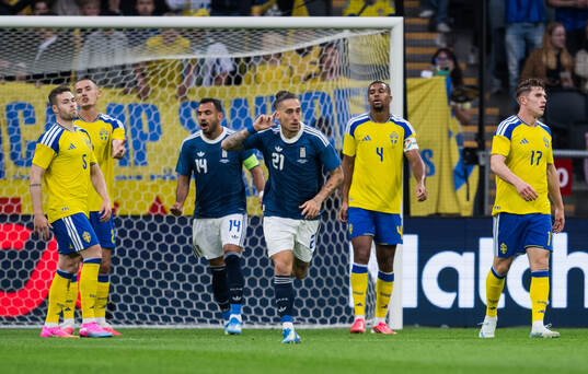Kostas Tsimikas of Greece celebrates