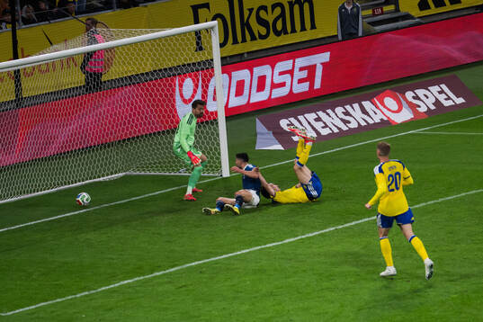 Giorgos Masouras of Greece scores 2-2 past goalkeeper