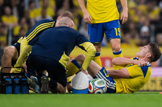 Viktor Gyökeres of Sweden receives medical attention