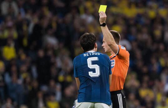 Panagiotis Retsos of Greece receives a yellow card from