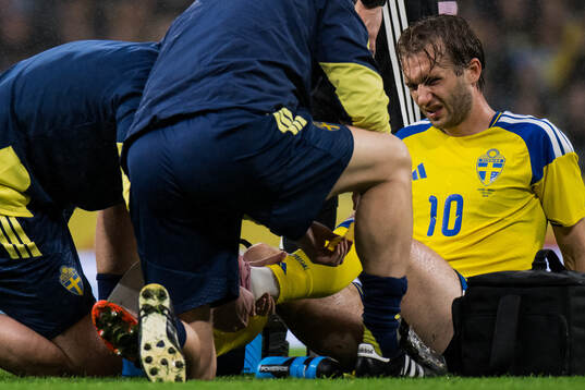 Benjamin Nygren of Sweden receives medical attention