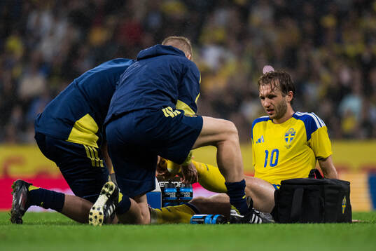 Benjamin Nygren of Sweden receives medical attention