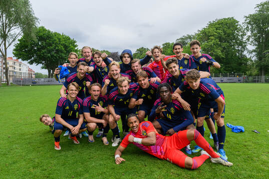 Players of the blue team celebrate winning
