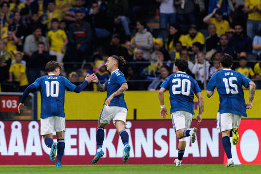 Kostas Tsimikas of Greece celebrates with team mates