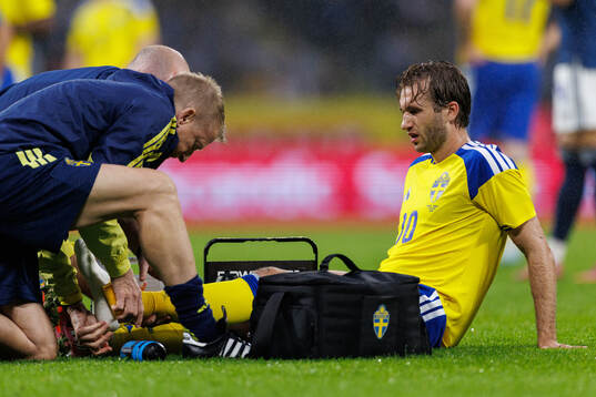 Benjamin Nygren of Sweden receives medical attention
