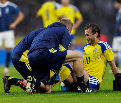 Benjamin Nygren of Sweden receives medical attention