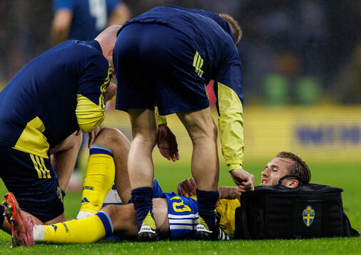 Benjamin Nygren of Sweden receives medical attention